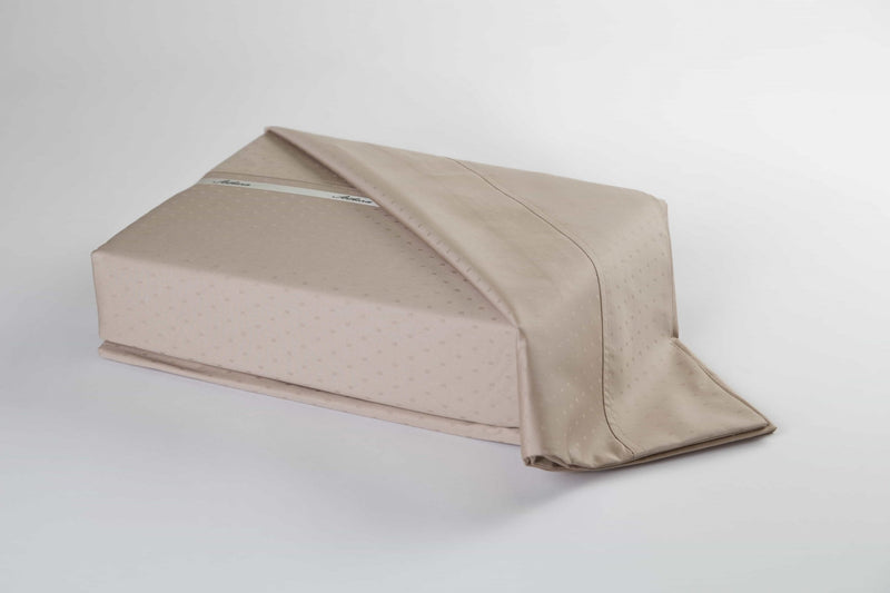 A Swiss Dot bed sheets set in taupe