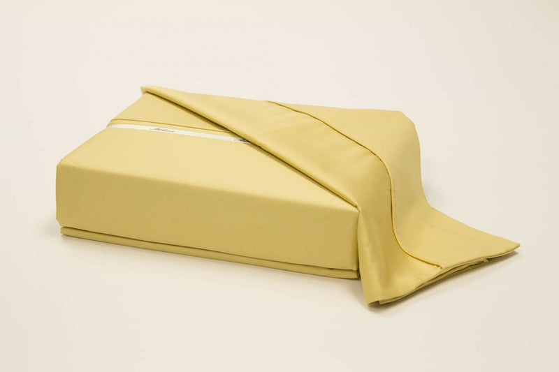 A 100% Long staple egyptian cotton sheet set including pillow cases in a yellow or gold color