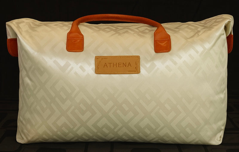 A white silk duvet from Athena inside its package case. The luxury duvet is filled with mulberry silk filling and has a 100 percent long staple cotton shell. The package looks like a high end bag.