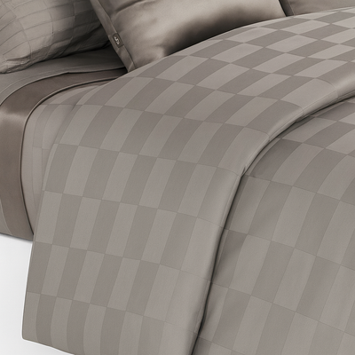 A checker pattern sheet set and duvet cover set in silver grey color on a bed from Hometrend, a Canadian Bedding store 