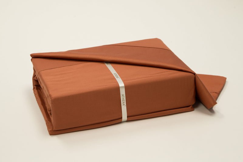 A 100% Long staple Egyptian cotton sheet set including pillow cases in a rust color